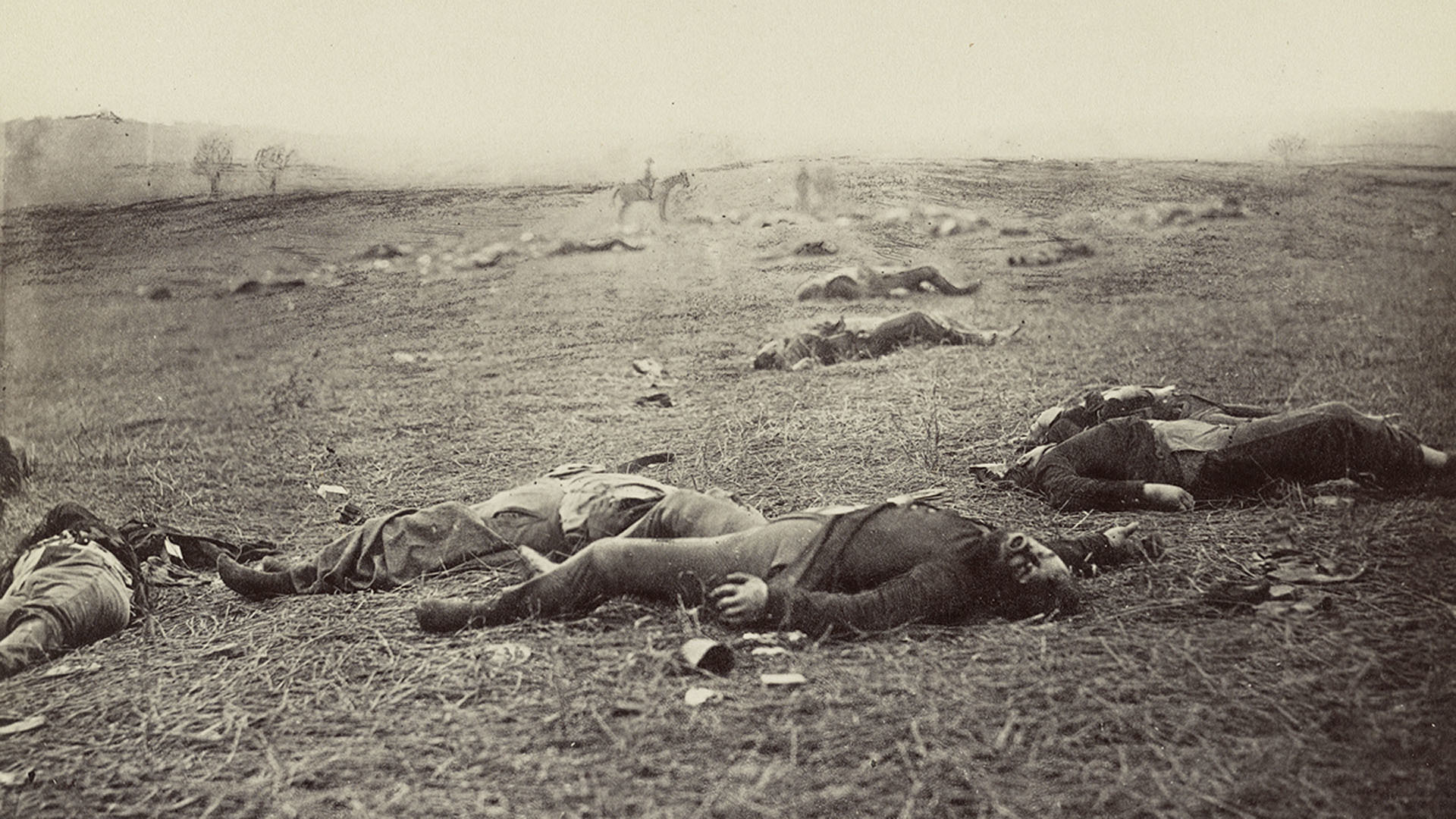 A sepia-toned photo of dead Union soldiers laying on the ground at Gettysburg, Pennsylvania, circa 1863.