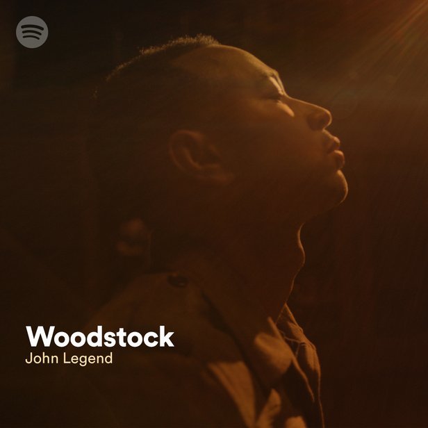 A promotional image of John Legend with the text "John Legend - Woodstock"
