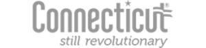 A logo for the Connecticut Office of Tourism. It shows the word Connecticut with a flag motif partially obscuring the final t. Underneath it says "still revolutionary."