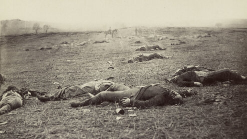 A sepia-toned photo of dead Union soldiers laying on the ground at Gettysburg, Pennsylvania, circa 1863. | Episode 5 | The Universe of Battle (1863)
