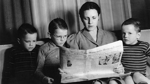 Jim Sherman's mother reads the paper to Roger, Charles and Jim. She did this every night so they would know the world news. They saved the headlines in a scrapbook from 1939 to 1945. | Communication